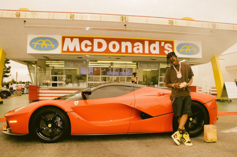 Travis Scott stands in front of the oldest McDonald's restaurant (Florence Avenue in Downey, California) with his red Ferrari. Credits to @rayscorruptedmind