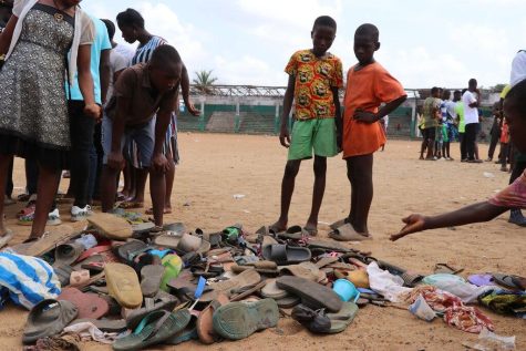 People search through piles of shoes left in a panicked stampede in Monrovia, Liberia, that left 29 people dead.