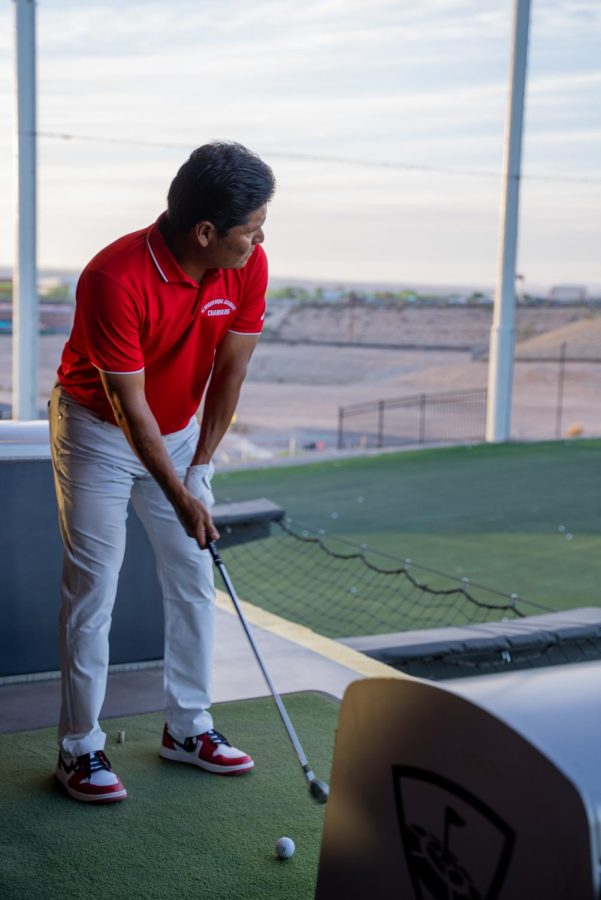 Notah Begay (90) lines up his shot at the Charger Challenge at Top Golf in April 2022.