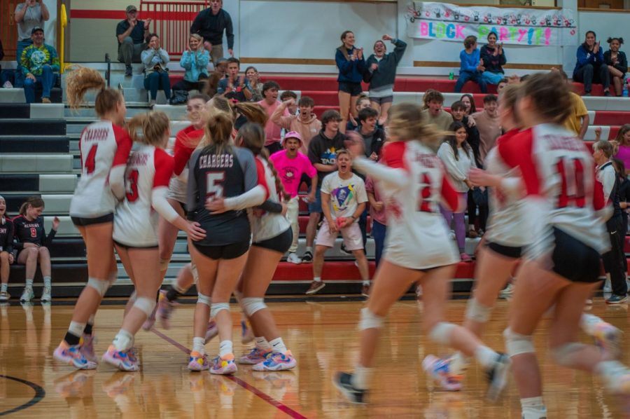 The Albuquerque Academy girls volleyball team and their fans celebrating after the teams win against Hope Christian School. 