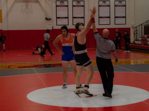 Michael Hulett 23 with his hand raised in triumph after dominating his competition.