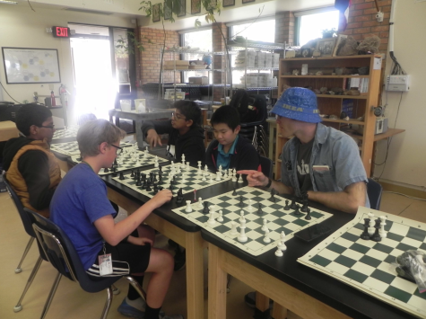 Chess team players analyze their boards
