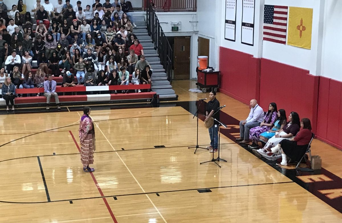 Dakota Skye on the hand drum as Shante Jensen performs a traditional dance