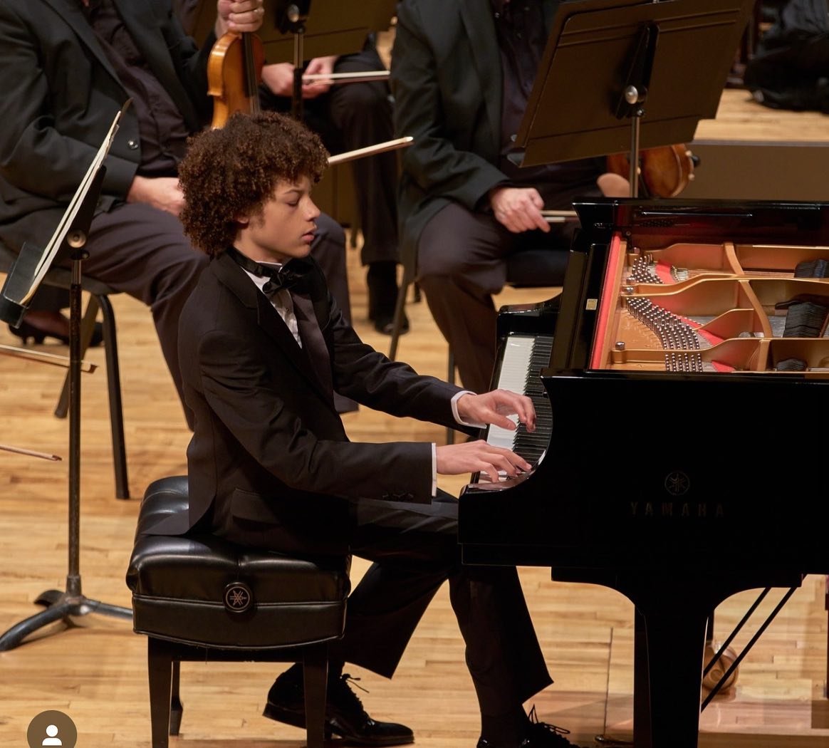 Pianist Kayden Kelly 25 dramatically playing Liszt on stage in Cincinnati.