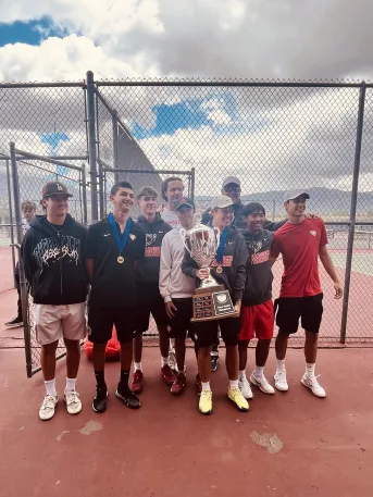 Academy tennis team posing with their first place trophy