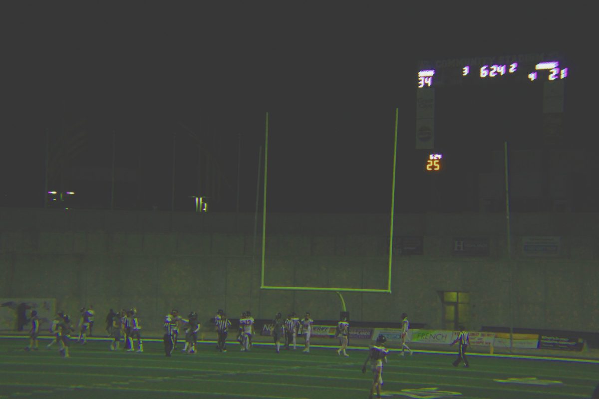 The St. Pius Spartans do their extra point kick while the scoreboard looms over the to-be defeated chargers