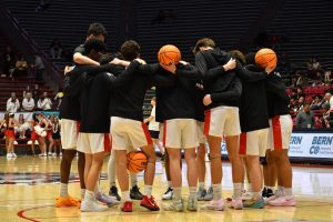 The Academy Chargers huddle up moments before tip-off against Highland during the semifinal game at the Pit on Thursday, March 13.