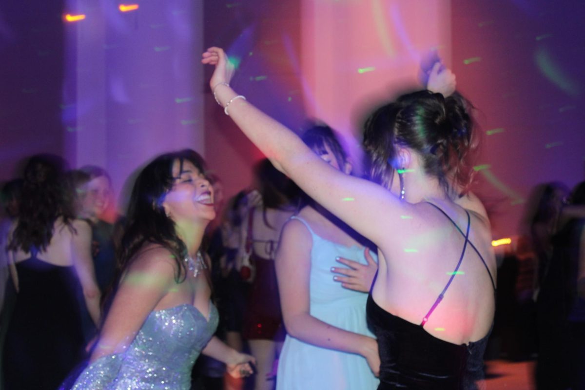 Sophomore Class Officer Abby D '28 dancing with Monica '26 and Ivy '27