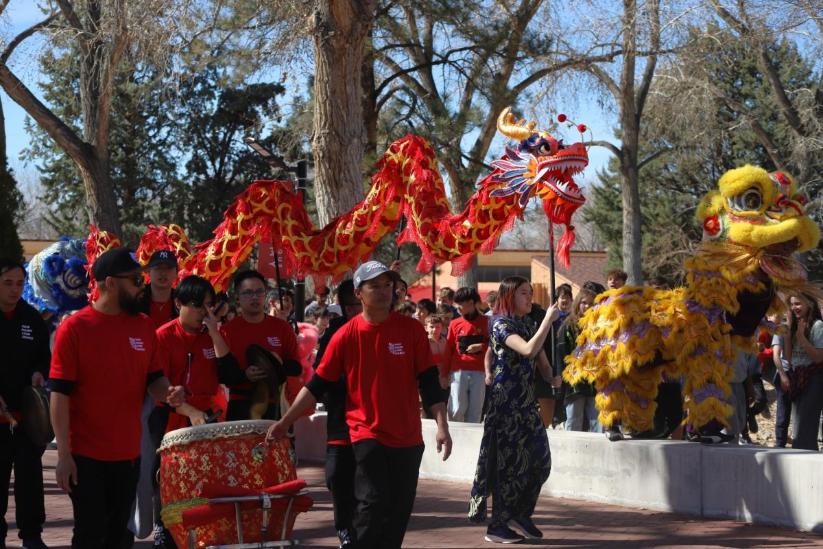 Sabina '27 leads a dragon that marches alongside the Van Hanh drummers